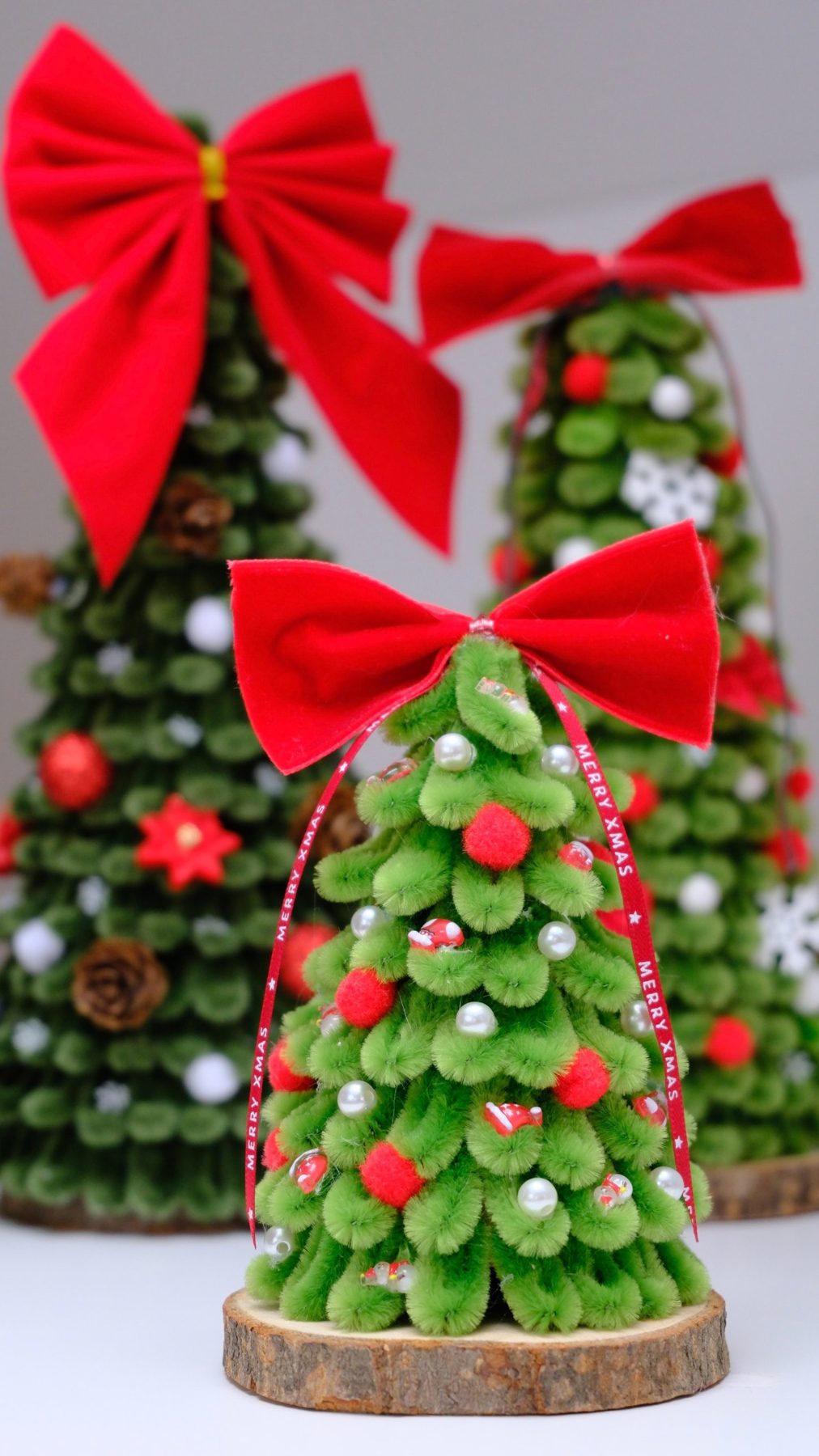 Kleiner hellgrüner Baum mit Perlen und „Merry Xmas“-Band